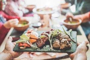 Chef,Woman,Serving,Dry,Tomatoes,,Cooked,Artichokes,peppers,Inside,Vegetarian,Gourmet
